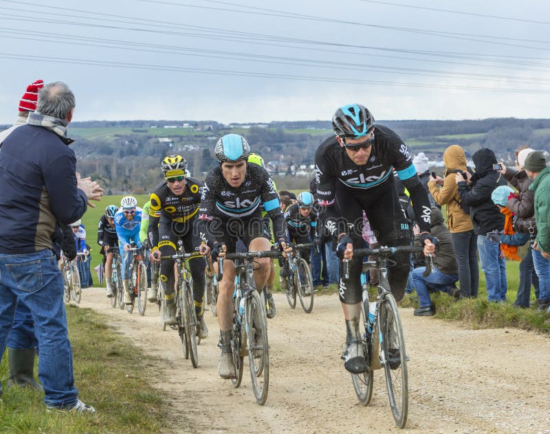 Vendome,France- March 7,2016:The peloton riding on a dirty road,Tertre de la Motte, in Vendome, during the first stage of Paris-Nice 2016. Vendome,France- March 7,2016:The peloton riding on a dirty road,Tertre de la Motte, in Vendome, during the first stage of Paris-Nice 2016.