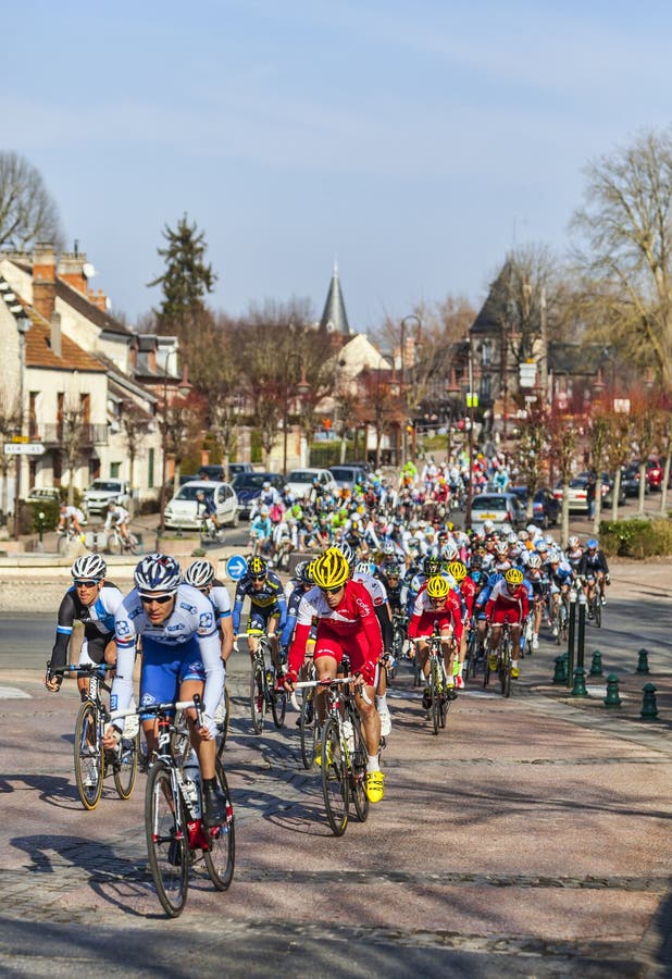 Saint-Pierre-lès-Nemours,France- March 4, 2013: Image of the peloton riding fastly, during the first stage of the famous road bicycle race Paris-Nice, on March 4, 2013 in Saint-Pierre-lès-Nemours. Saint-Pierre-lès-Nemours,France- March 4, 2013: Image of the peloton riding fastly, during the first stage of the famous road bicycle race Paris-Nice, on March 4, 2013 in Saint-Pierre-lès-Nemours.