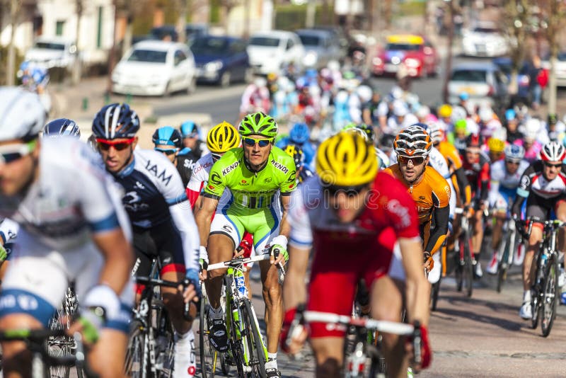 Saint-Pierre-lès-Nemours,France- March 4, 2013: Image of the peloton riding fastly, during the first stage of the famous road bicycle race Paris-Nice, on March 4, 2013 in Saint-Pierre-lès-Nemours. Saint-Pierre-lès-Nemours,France- March 4, 2013: Image of the peloton riding fastly, during the first stage of the famous road bicycle race Paris-Nice, on March 4, 2013 in Saint-Pierre-lès-Nemours.