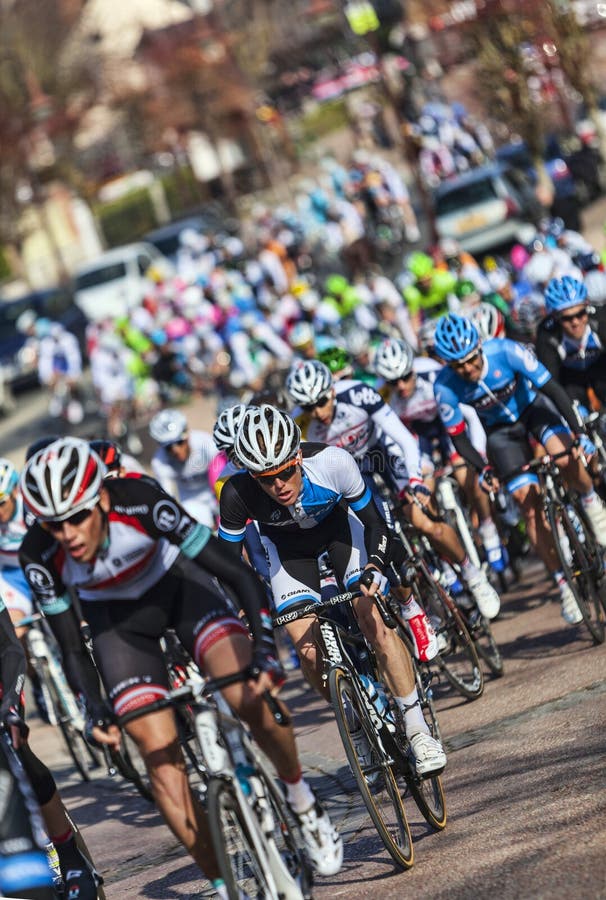 Saint-Pierre-lès-Nemours,France- March 4, 2013: Image of the peloton riding fastly, during the first stage of the famous road bicycle race Paris-Nice, on March 4, 2013 in Saint-Pierre-lès-Nemours. Saint-Pierre-lès-Nemours,France- March 4, 2013: Image of the peloton riding fastly, during the first stage of the famous road bicycle race Paris-Nice, on March 4, 2013 in Saint-Pierre-lès-Nemours.