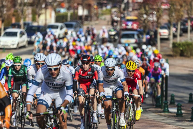 Saint-Pierre-lès-Nemours,France- March 4, 2013: Image of the peloton riding fastly, during the first stage of the famous road bicycle race Paris-Nice, on March 4, 2013 in Saint-Pierre-lès-Nemours. Saint-Pierre-lès-Nemours,France- March 4, 2013: Image of the peloton riding fastly, during the first stage of the famous road bicycle race Paris-Nice, on March 4, 2013 in Saint-Pierre-lès-Nemours.