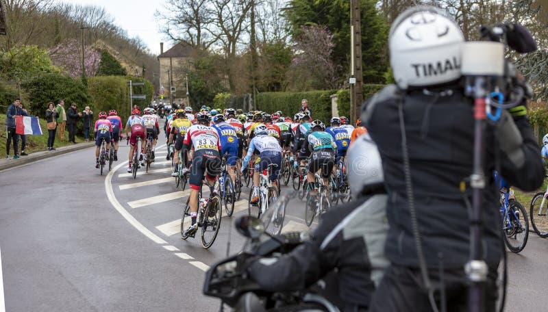 Beulle, France - March 10, 2019: Rear view of the peloton riding on Cote de Beulle during the stage 1 of Paris-Nice 2019. Beulle, France - March 10, 2019: Rear view of the peloton riding on Cote de Beulle during the stage 1 of Paris-Nice 2019