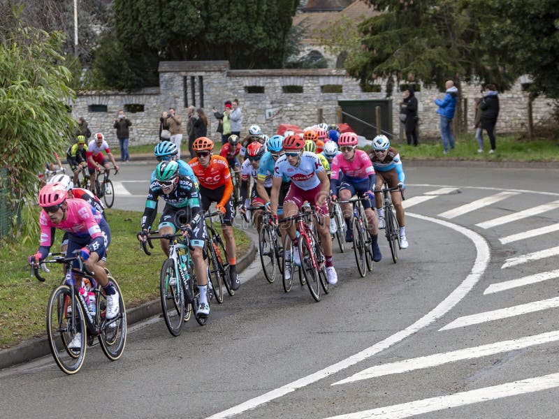 Beulle, France - March 10, 2019: The peloton riding on Cote de Beulle during the stage 1 of Paris-Nice 2019. Beulle, France - March 10, 2019: The peloton riding on Cote de Beulle during the stage 1 of Paris-Nice 2019