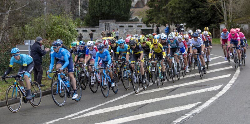 Beulle, France - March 10, 2019: The peloton riding on Cote de Beulle during the stage 1 of Paris-Nice 2019. Beulle, France - March 10, 2019: The peloton riding on Cote de Beulle during the stage 1 of Paris-Nice 2019