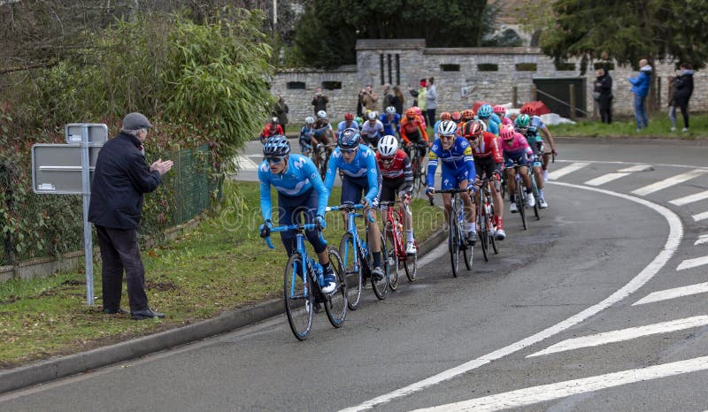 Beulle, France - March 10, 2019: The peloton riding on Cote de Beulle during the stage 1 of Paris-Nice 2019. Beulle, France - March 10, 2019: The peloton riding on Cote de Beulle during the stage 1 of Paris-Nice 2019