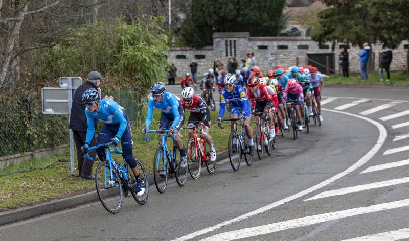 Beulle, France - March 10, 2019: The peloton riding on Cote de Beulle during the stage 1 of Paris-Nice 2019. Beulle, France - March 10, 2019: The peloton riding on Cote de Beulle during the stage 1 of Paris-Nice 2019