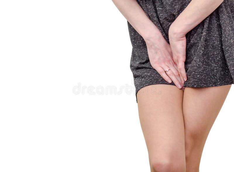 woman covering her crotch with her hands on white background Stock Photo