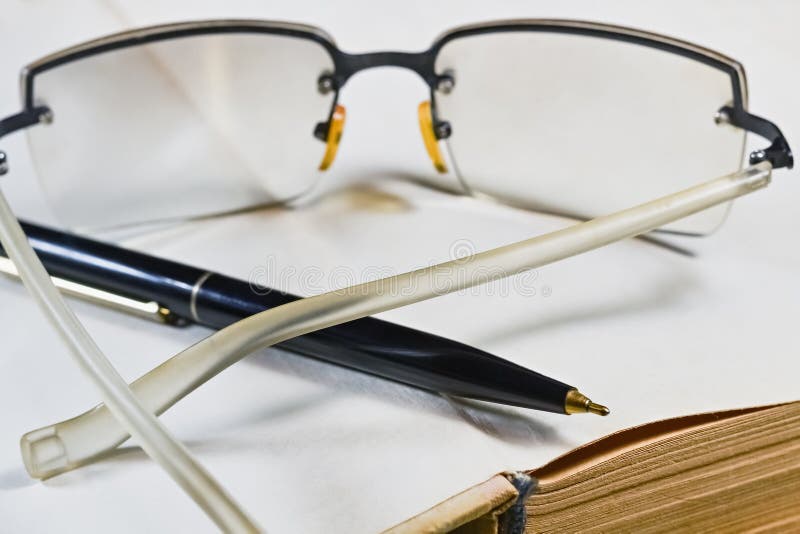 Close up 1. Book Pen and Glasses. Golden Glasses book.