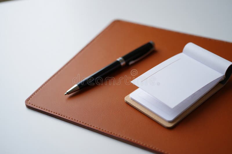 Elegant Workspace Flat Lay Featuring Pen and Notepad on Leather Mat for Professional Writing Note Taking and Organized Office vector illustration