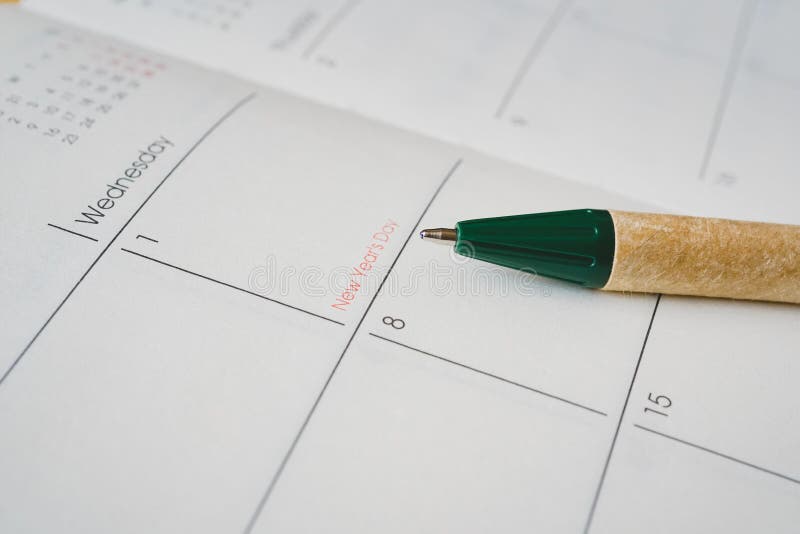 Pen pointed at New Year`s Day on opened planner page. Ball pen pointed at New Year`s Day on opened planner page stock images Pen pointed at New Year`s Day on opened planner page. Ball pen pointed at New Year`s Day on opened planner page stock images