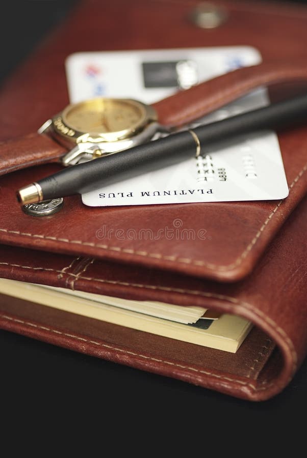 Pen,watch and a credit card on an agenda royalty free stock photography Pen,watch and a credit card on an agenda royalty free stock photography