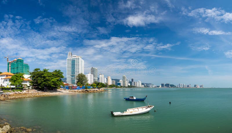 Penang  Malaysia  Georgetown. City panorama at the sea coast promenade  hotel and fishing boat view. Penang  Malaysia  Georgetown. City panorama at the sea coast promenade  hotel and fishing boat view...