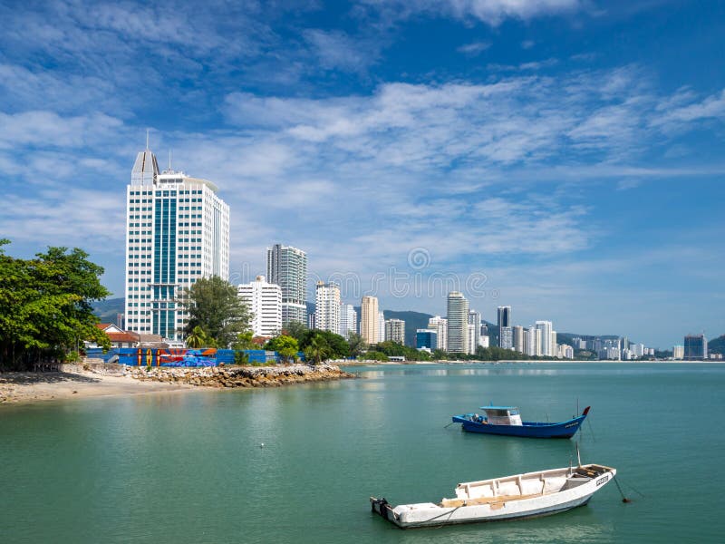 Penang  Malaysia  Georgetown. City panorama at the sea coast promenade  hotel and fishing boat view. Penang  Malaysia  Georgetown. City panorama at the sea coast promenade  hotel and fishing boat view...