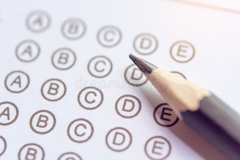 Pencil on answer sheets or Standardized test form with answers bubbled. multiple choice answer sheet stock photos