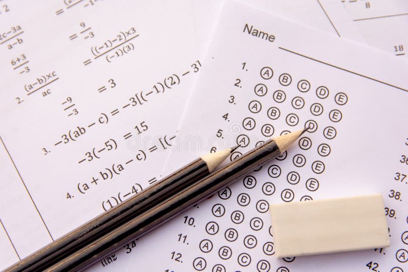 Pencil and eraser on answer sheets or Standardized test form with answers bubbled. multiple choice answer sheet stock images