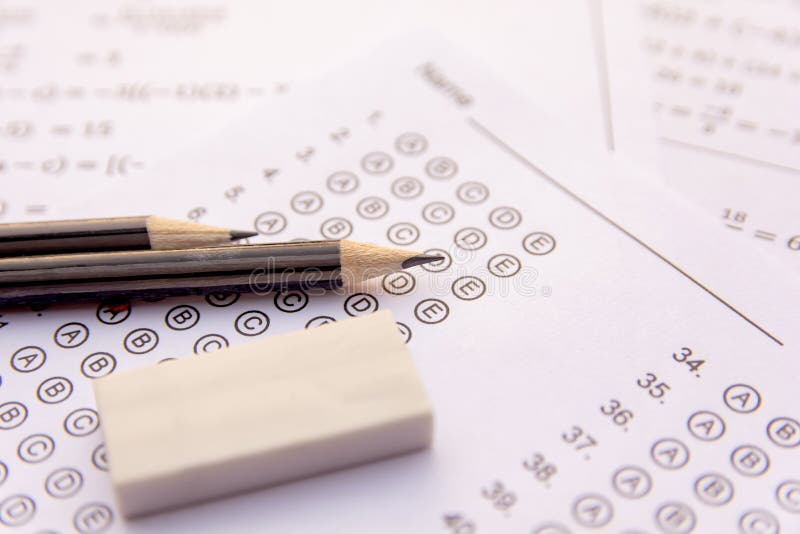 Pencil and eraser on answer sheets or Standardized test form with answers bubbled. multiple choice answer sheet stock images