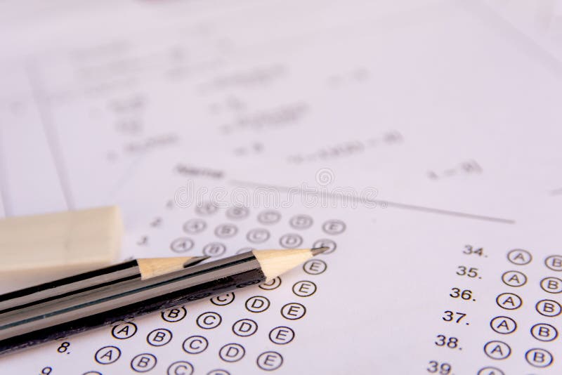 Pencil and eraser on answer sheets or Standardized test form with answers bubbled. multiple choice answer sheet stock photo