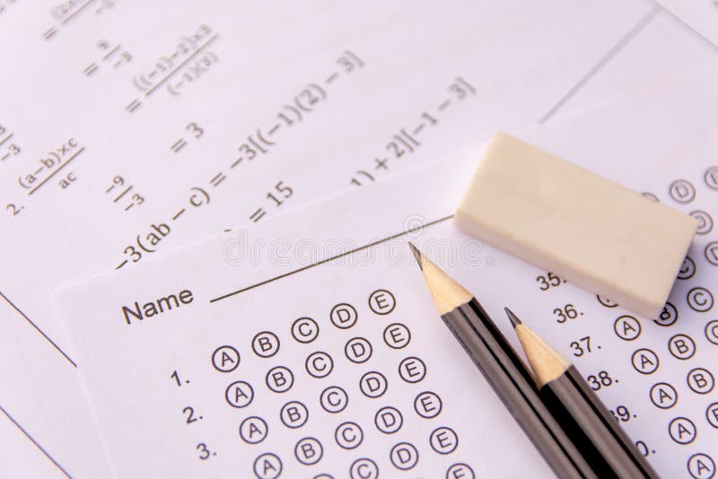 Pencil and eraser on answer sheets or Standardized test form with answers bubbled. multiple choice answer sheet royalty free stock photography