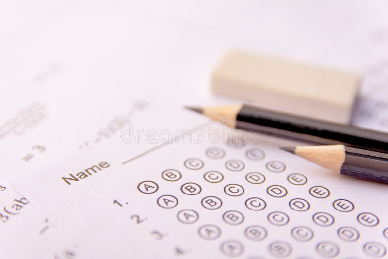 Pencil and eraser on answer sheets or Standardized test form with answers bubbled. multiple choice answer sheet stock image