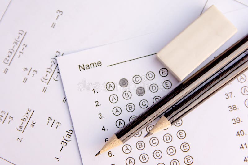 Pencil and eraser on answer sheets or Standardized test form with answers bubbled. multiple choice answer sheet stock photography