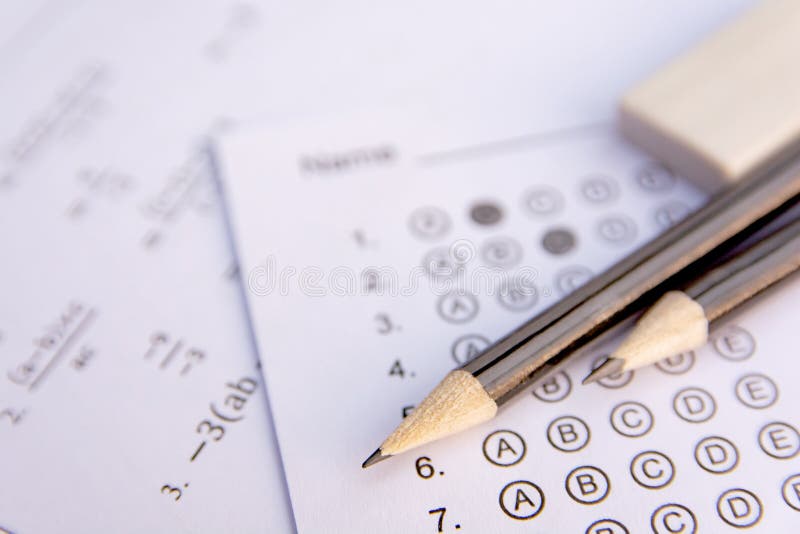 Pencil and eraser on answer sheets or Standardized test form with answers bubbled. multiple choice answer sheet royalty free stock photo