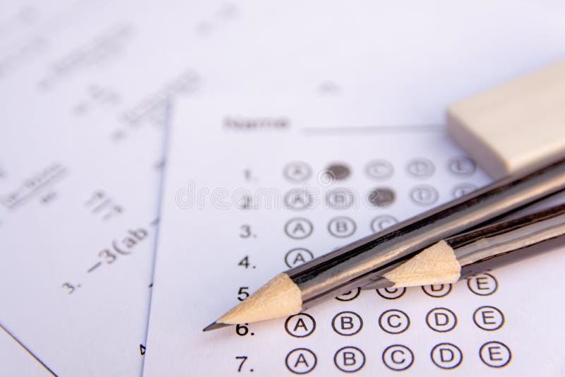 Pencil and eraser on answer sheets or Standardized test form with answers bubbled. multiple choice answer sheet stock images