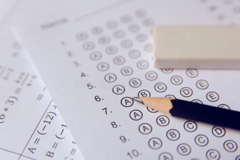 Pencil and eraser on answer sheets or Standardized test form with answers bubbled. multiple choice answer sheet royalty free stock images