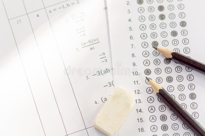 Pencil and eraser on answer sheets or Standardized test form with answers bubbled. multiple choice answer sheet stock photography