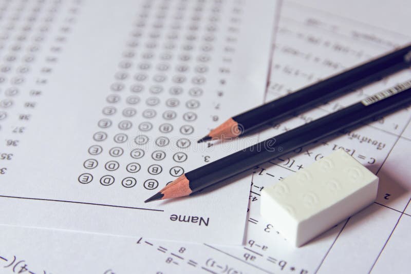 Pencil and eraser on answer sheets or Standardized test form with answers bubbled. multiple choice answer sheet stock photography