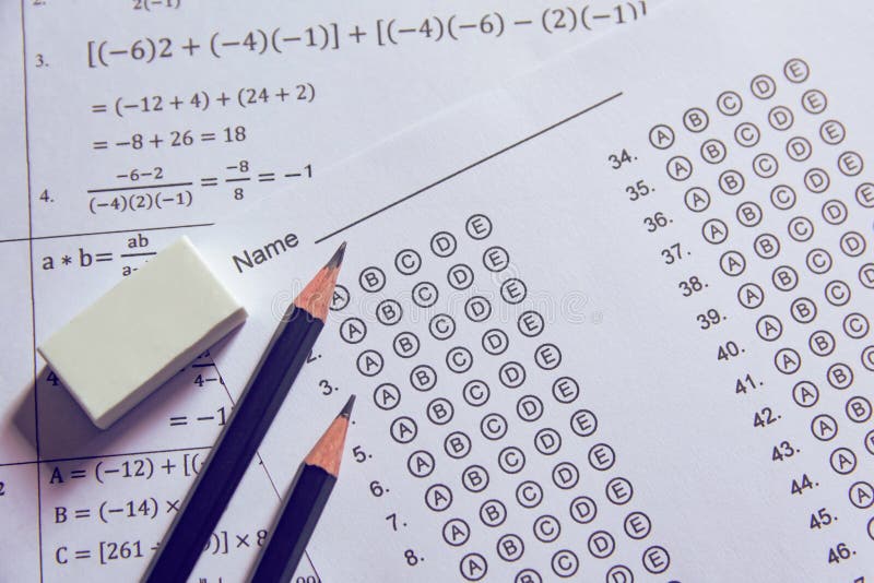 Pencil and eraser on answer sheets or Standardized test form with answers bubbled. multiple choice answer sheet stock image