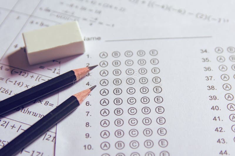 Pencil and eraser on answer sheets or Standardized test form with answers bubbled. multiple choice answer sheet stock images