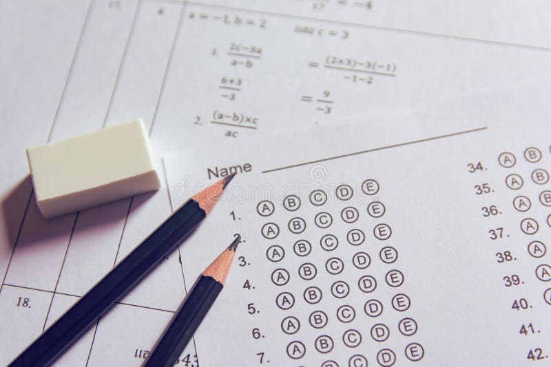 Pencil and eraser on answer sheets or Standardized test form with answers bubbled. multiple choice answer sheet royalty free stock photography