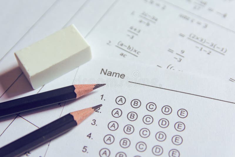 Pencil and eraser on answer sheets or Standardized test form with answers bubbled. multiple choice answer sheet stock image