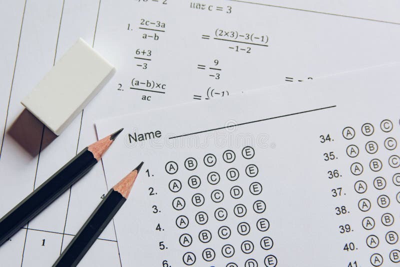 Pencil and eraser on answer sheets or Standardized test form with answers bubbled. multiple choice answer sheet stock photo