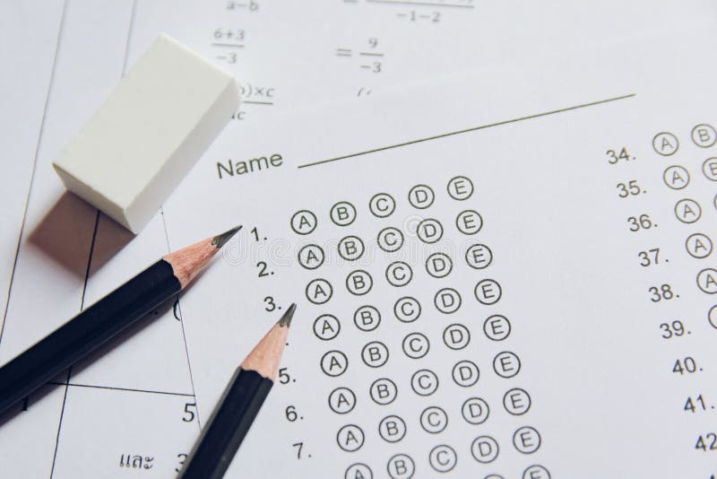 Pencil and eraser on answer sheets or Standardized test form with answers bubbled. multiple choice answer sheet royalty free stock images