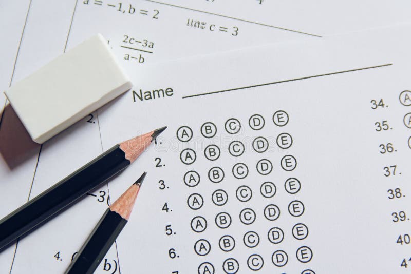 Pencil and eraser on answer sheets or Standardized test form with answers bubbled. multiple choice answer sheet royalty free stock image