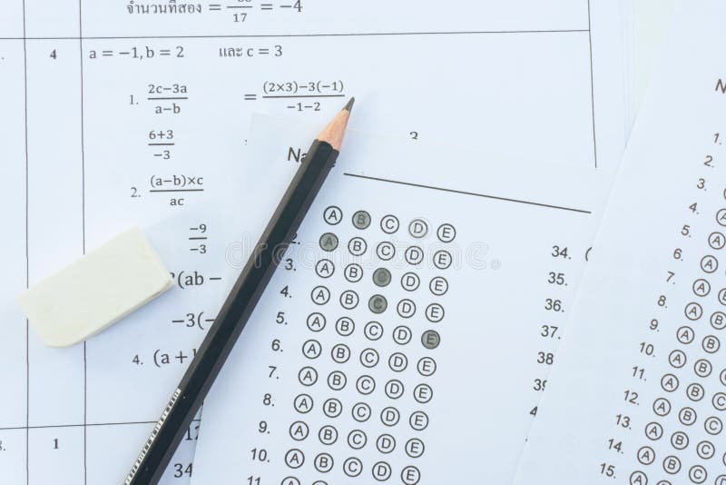 Pencil and eraser on answer sheets or Standardized test form with answers bubbled. multiple choice answer sheet stock image