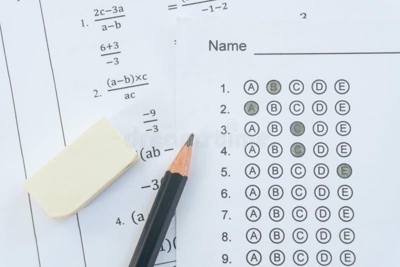 Pencil and eraser on answer sheets or Standardized test form with answers bubbled. multiple choice answer sheet royalty free stock photography