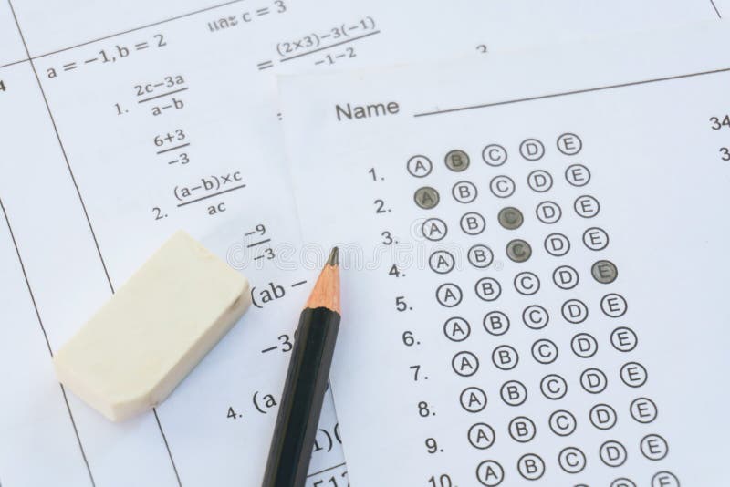 Pencil and eraser on answer sheets or Standardized test form with answers bubbled. multiple choice answer sheet royalty free stock images