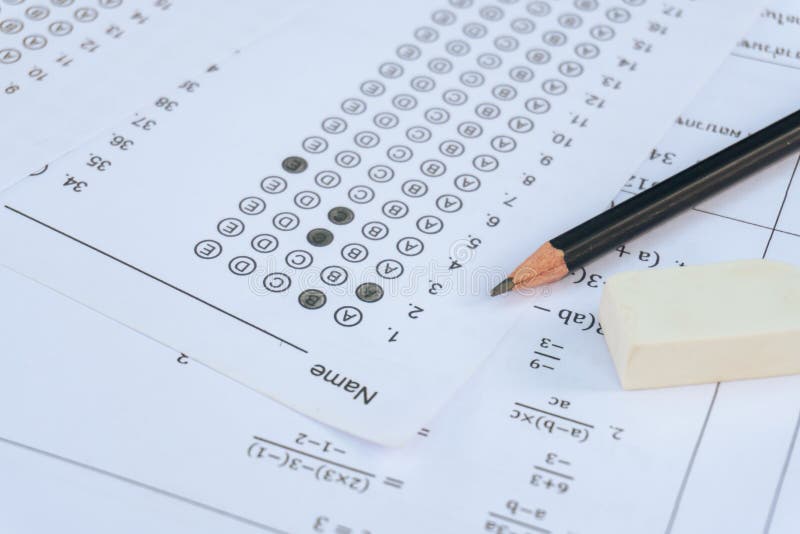 Pencil and eraser on answer sheets or Standardized test form with answers bubbled. multiple choice answer sheet royalty free stock image