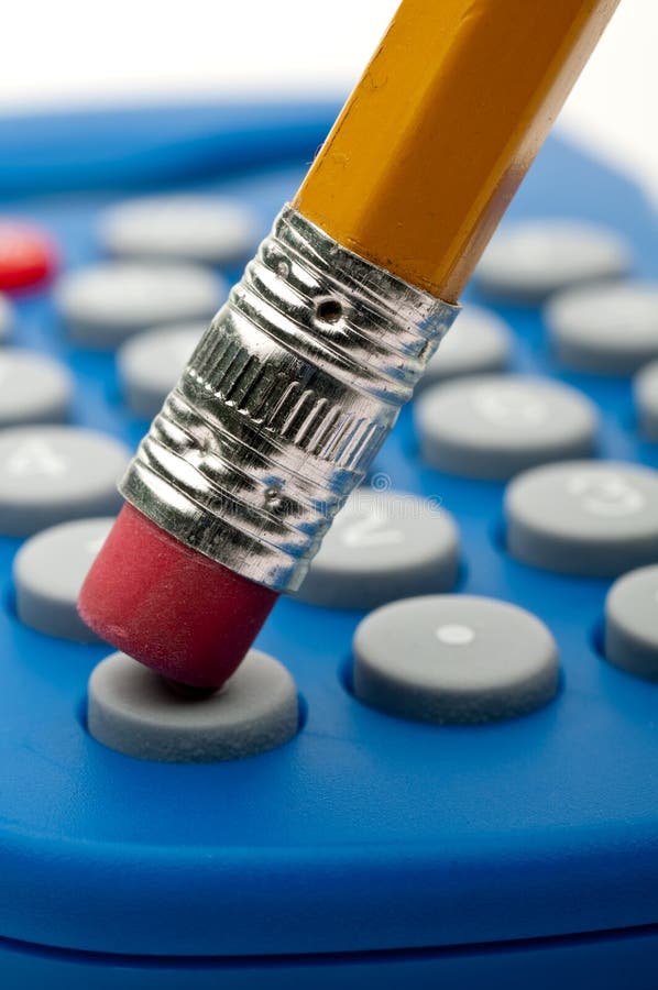 Pencil eraser pushing a calculator royalty free stock photo