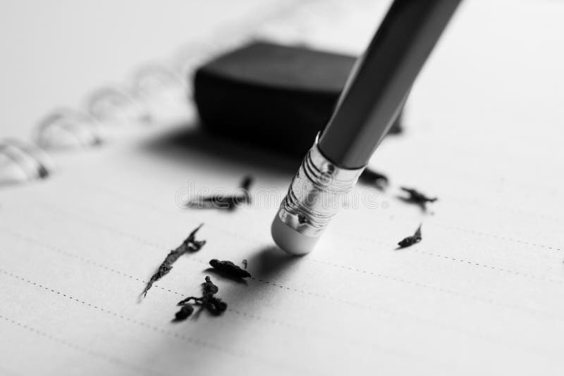 Pencil eraser removing a written mistake on a piece of paper, de royalty free stock photo