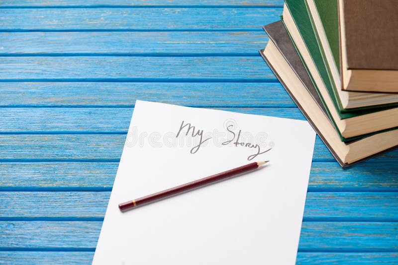 Pencil and paper with My Story words and books stock images Pencil and paper with My Story words and books stock images