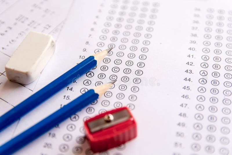 Pencil, Sharpener and eraser on answer sheets or Standardized te stock images