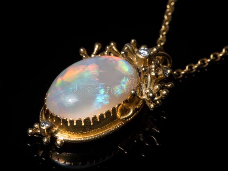 Closeup of a pendant of a necklace made of gold, opal gemstone