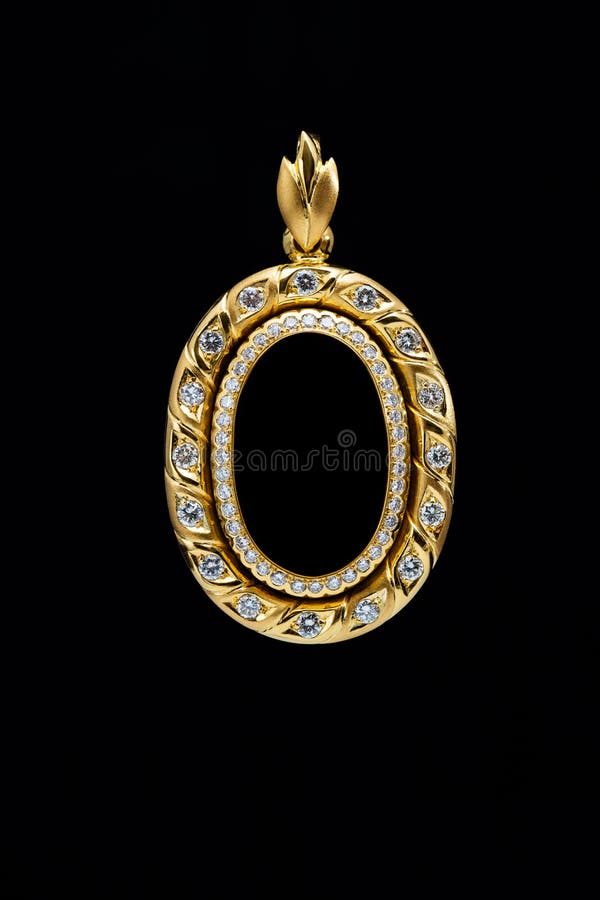 Gold locket frame pendant with diamond on black background. Gold locket frame pendant with diamond on black background