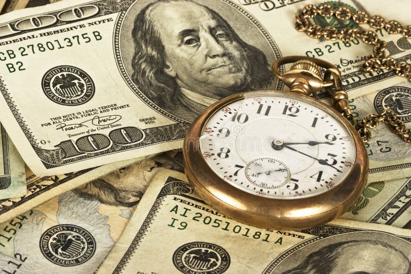 1800&#x27;s railroad pocket watch sitting on a stack of U.S. cash reflecting time and money. 1800&#x27;s railroad pocket watch sitting on a stack of U.S. cash reflecting time and money