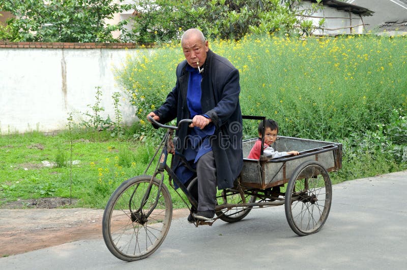 pengzhou-china-man-boy-bicycle-cart-24287620.jpg