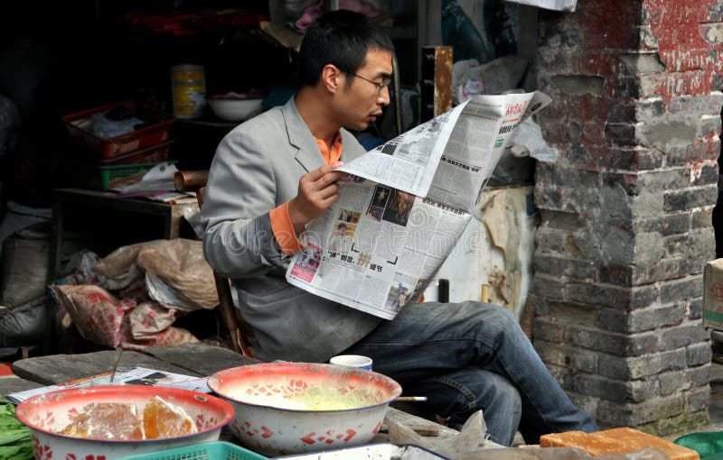 Pengzhou, China: Man Reading Newspaper royalty free stock photography