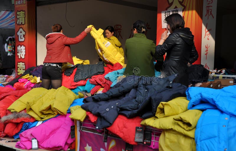 Women shopping for colourful winter jackets on sale at a small clothing store in Pengzhou, China. Women shopping for colourful winter jackets on sale at a small clothing store in Pengzhou, China.